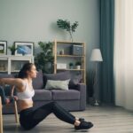 Woman doing tricep dips at home using a chair for support, promoting fitness indoors, illustrating 15 At-Home Workouts That Actually Work: No Equipment Needed
