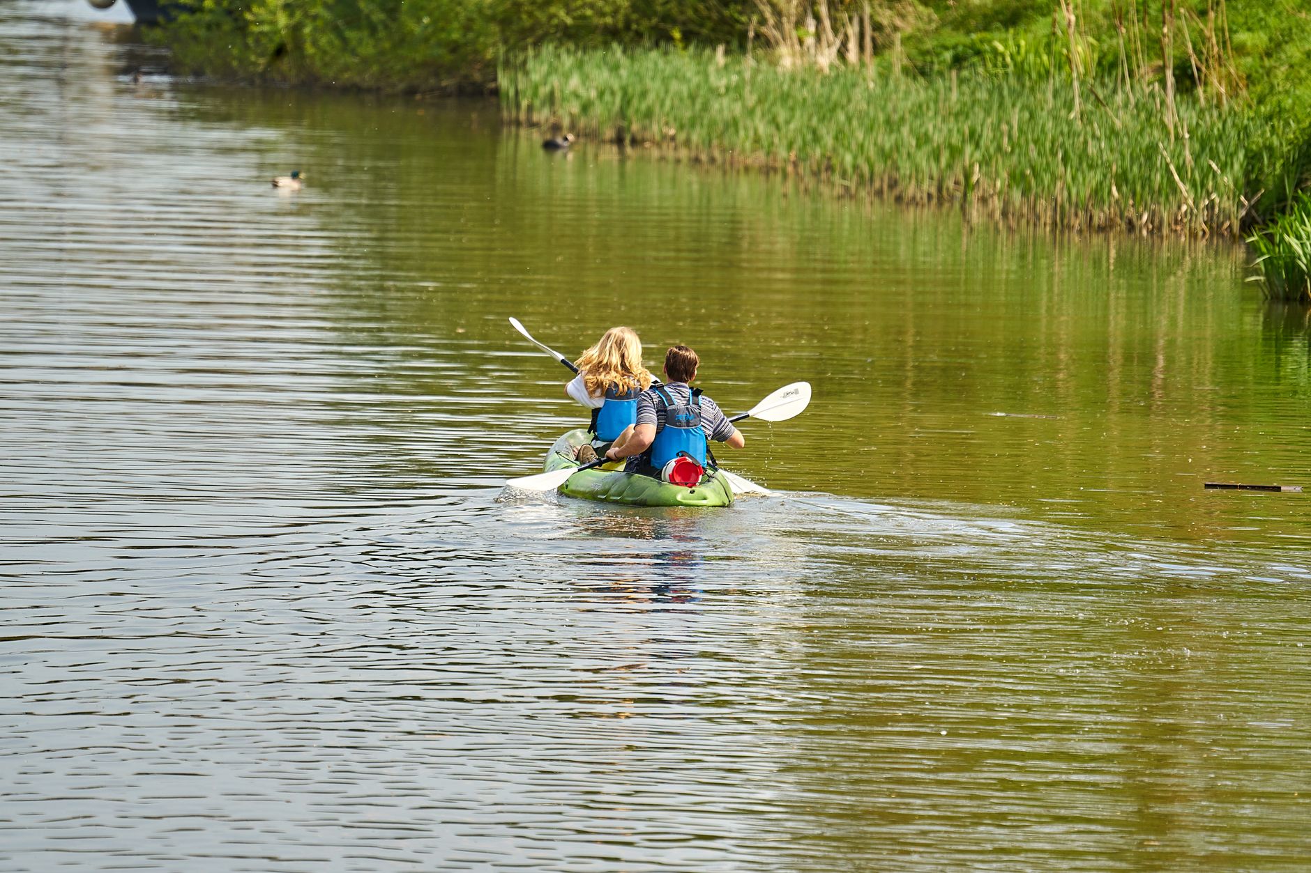 Couple kayaking together, trying something new on vacation