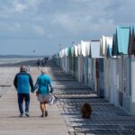 Couple walking together through a seaside town on their first vacation together