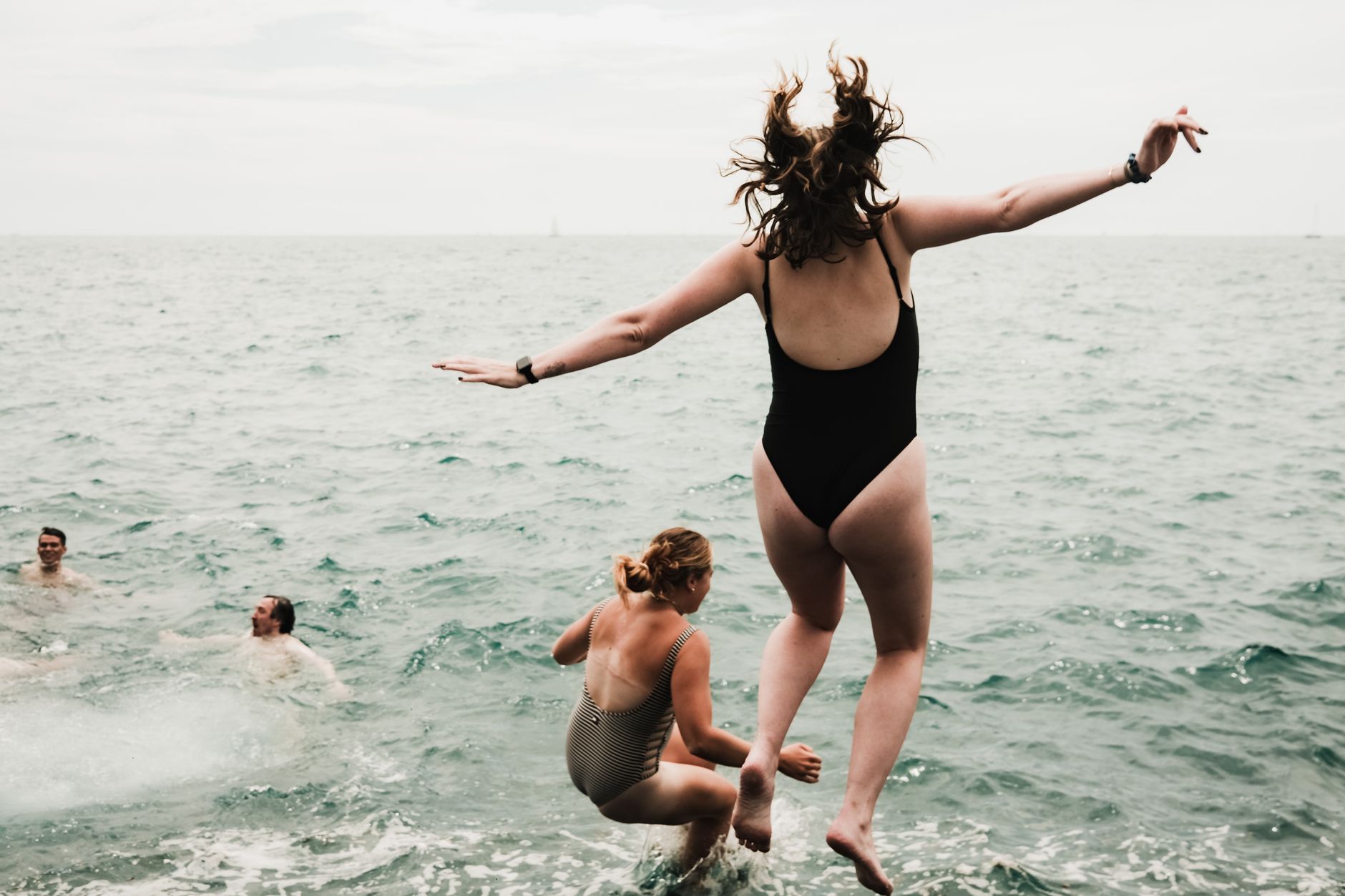 Friends at a lake on a sunny summer weekend, when reapplying sunscreen matters most