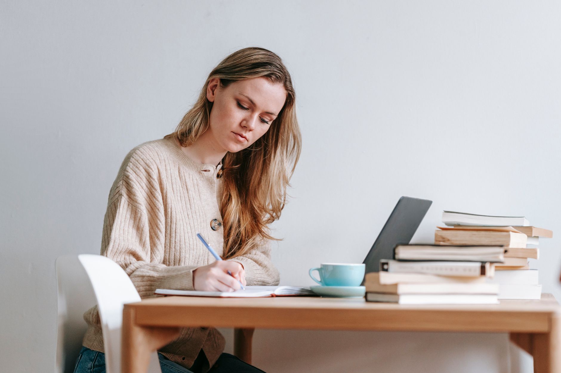 Woman at her desk drafting notes about her own work accomplishments