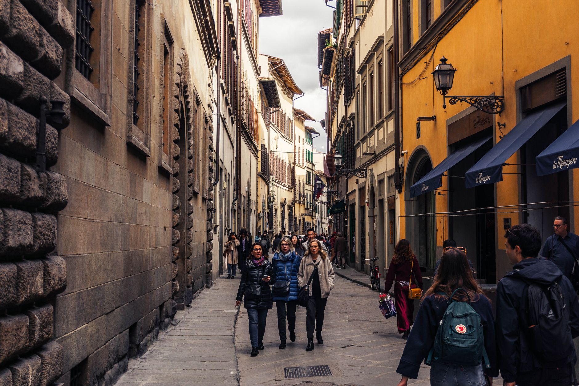 Tourists walking a street in Florence, Italy, a top summer destination for insured travelers