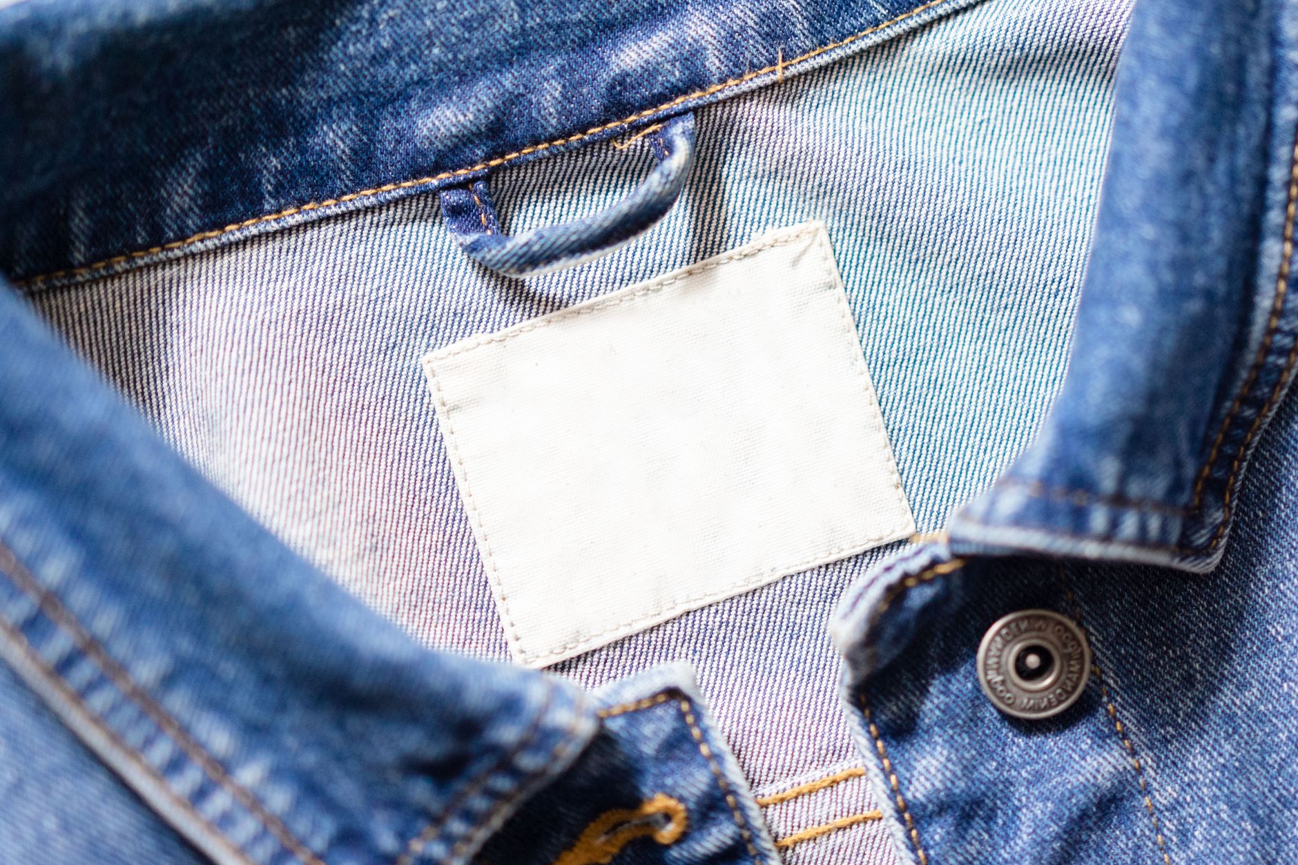 Close-up of a clothing fiber content label being checked before buying a summer top