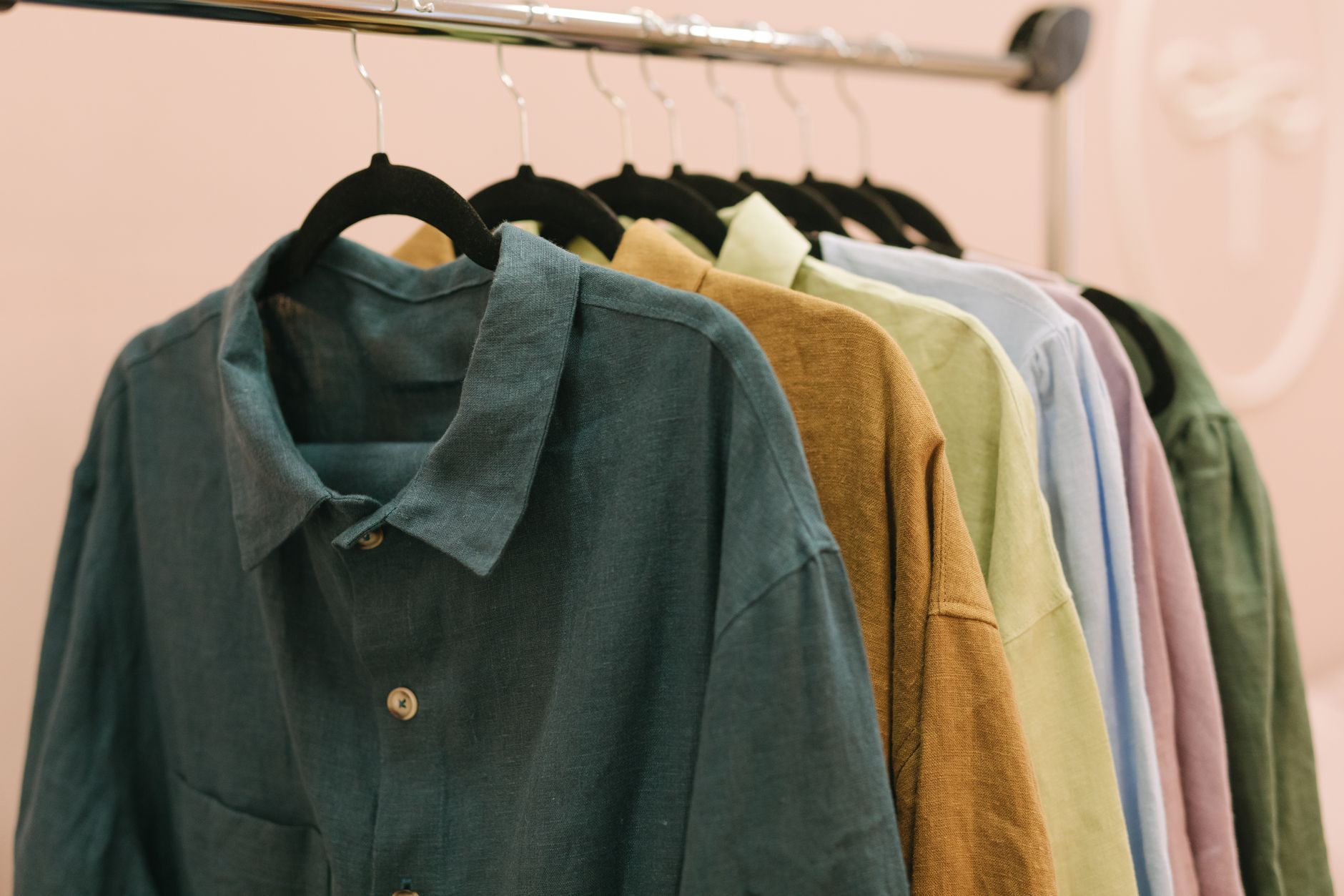 Linen shirts hanging on a rack, slightly wrinkled from wear