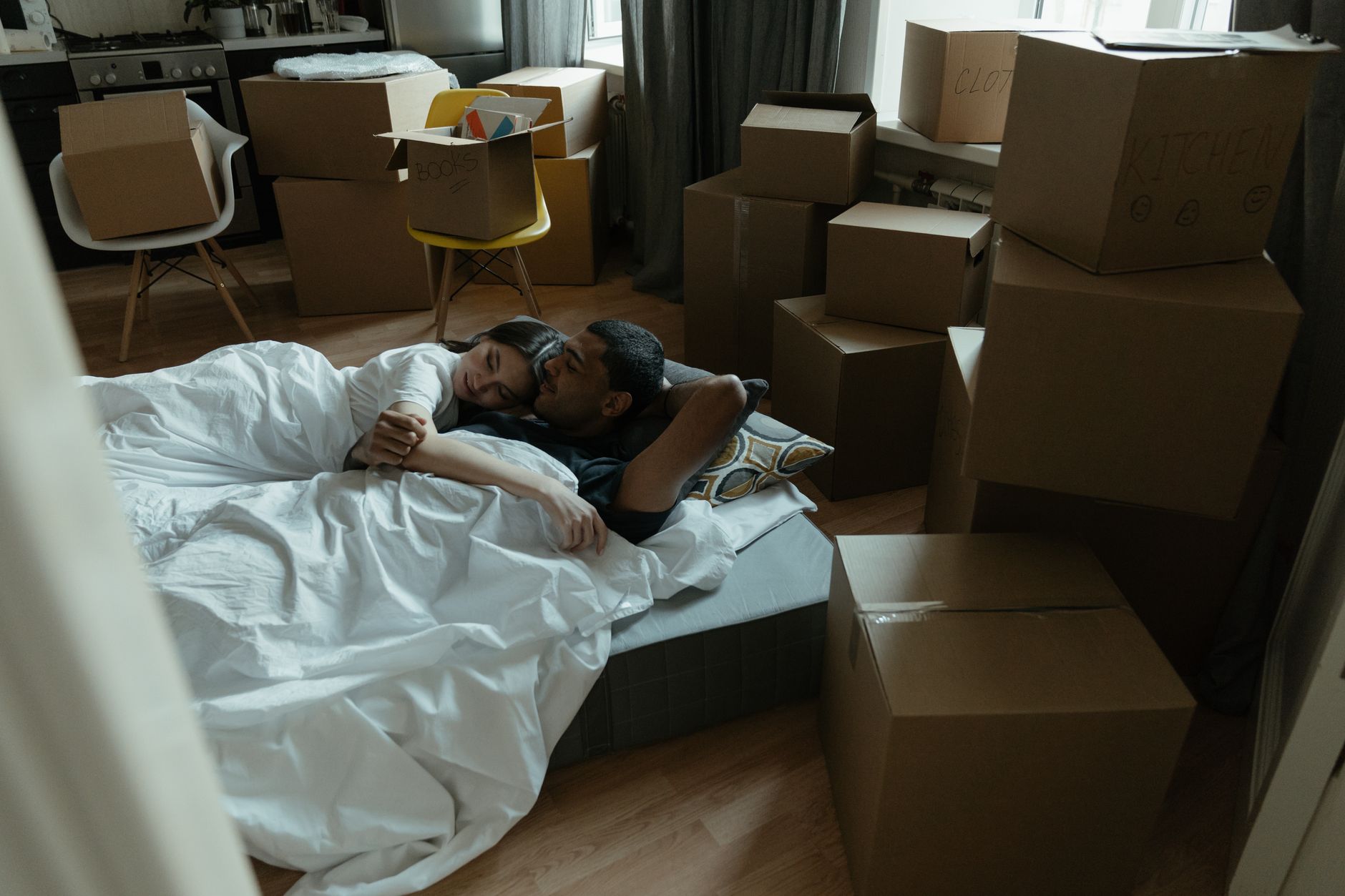Rolled bed-in-a-box mattress being unboxed in a bedroom at the start of its sleep trial