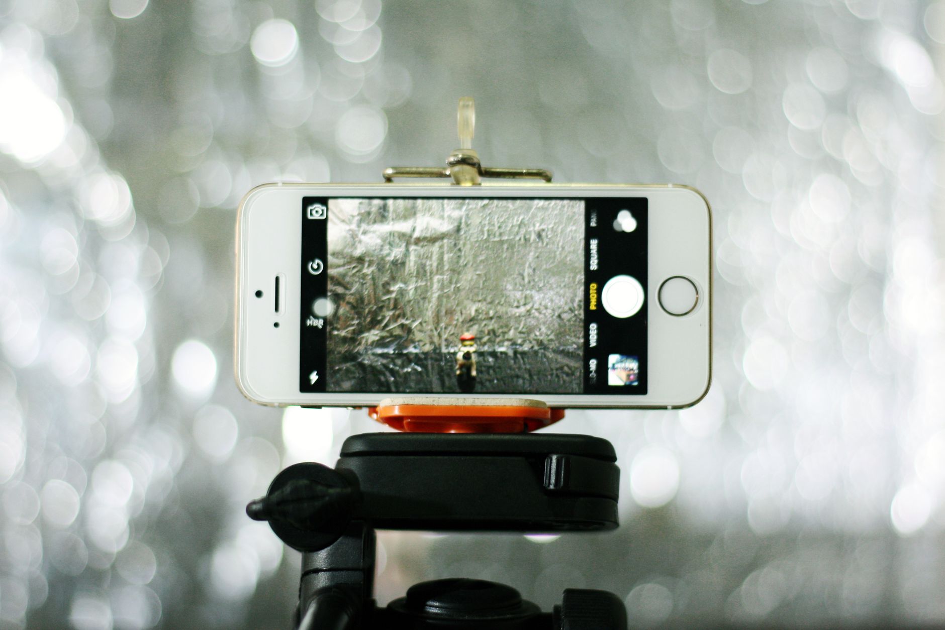 Smartphone on a small tripod set up to take a self-timer family photo